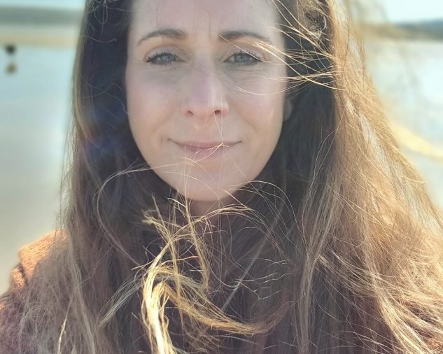 A warm and approachable woman smiling confidently, creating a safe and welcoming space for transformation and healing.